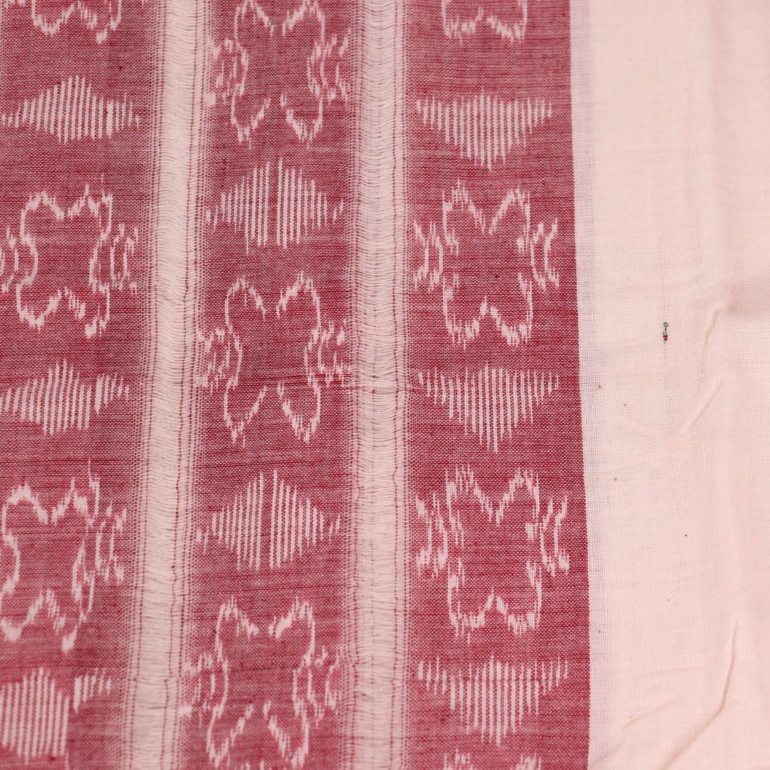 White and red Sambalpuri cotton dupatta with intricate motif patterns, draped over a traditional outfit