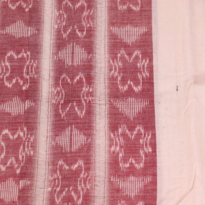 White and red Sambalpuri cotton dupatta with intricate motif patterns, draped over a traditional outfit