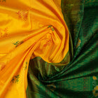 Extreme close-up of yellow Bomkai Silk Saree fabric, revealing the rich silk texture and weave.