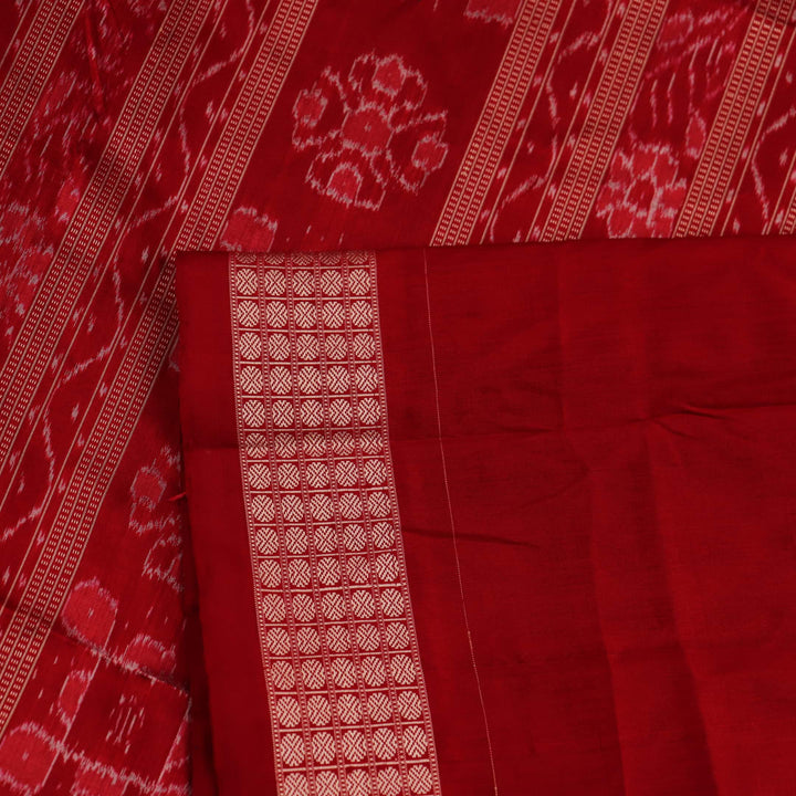 Close-up view of the blue silk Sambalpuri saree's fabric texture showcasing intricate motifs in red