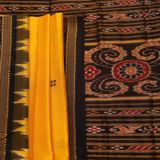 Model showcasing yellow Khandua silk saree with black butta pattern.