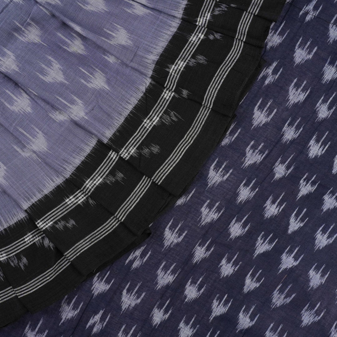 Model wearing a grey and black Sambalpuri cotton saree with traditional ikat motifs in a classic ethnic drape.