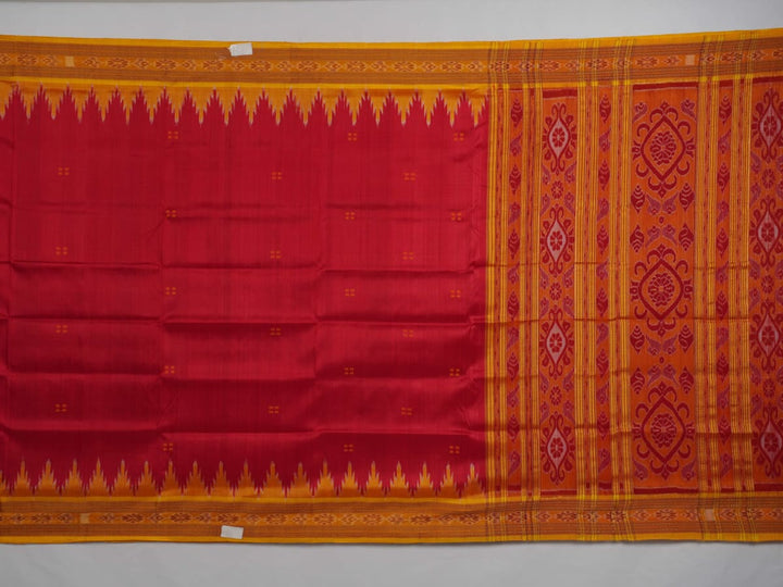 Model draped in a red and yellow Khandua silk saree with butta patterns for a traditional look.