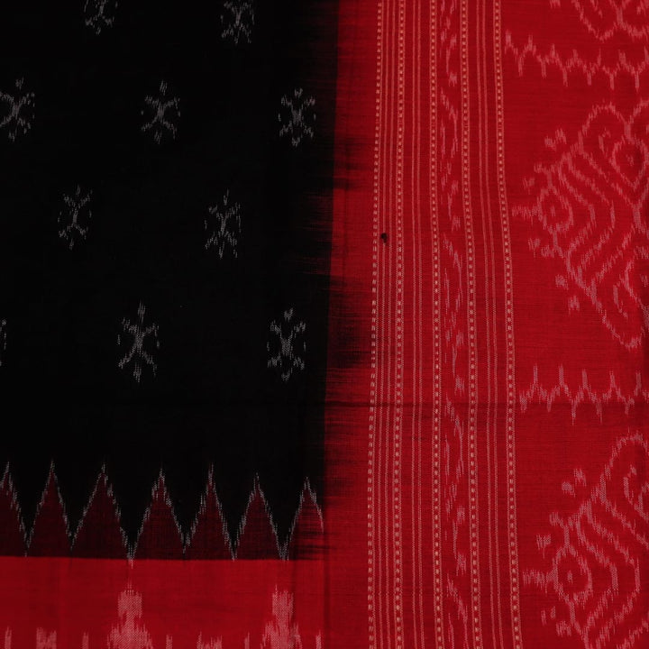 Close-up of a lightweight, black cotton Sambalpuri dupatta with red motifs in the border