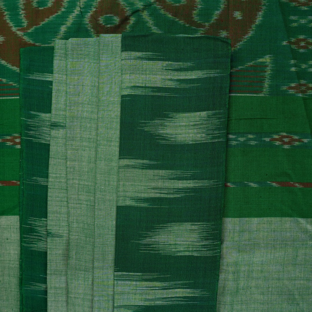 Model wearing a plain green Sambalpuri cotton saree styled elegantly to show the full handloom drape
