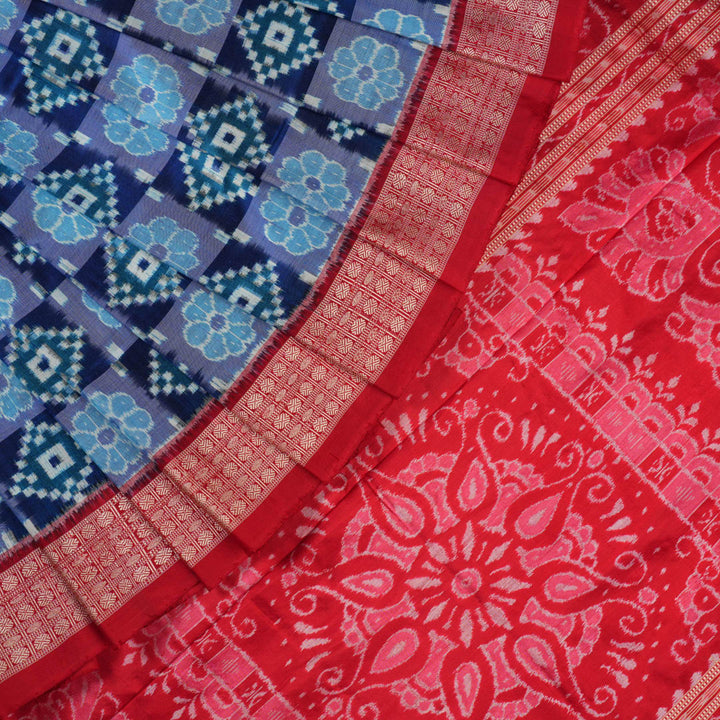 Close-up of the luxurious silk fabric texture and distinctive Sambalpuri ikat weave of the blue Pasapalli saree.