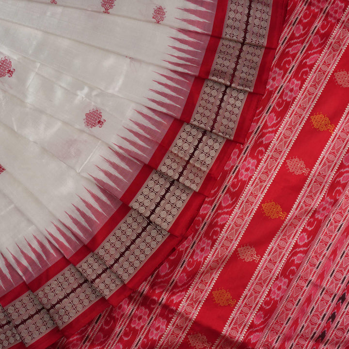 Extreme close-up revealing the rich Bomkai silk fabric texture and intricate handloom weave details in white and red.