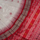 Extreme close-up revealing the rich Bomkai silk fabric texture and intricate handloom weave details in white and red.