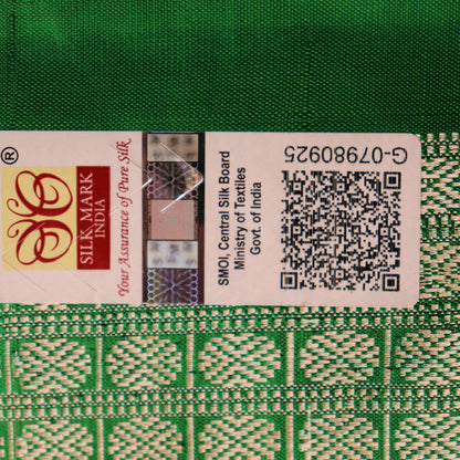 Close-up showcase of the exquisite silk texture with intricate motifs in a black and green Sambalpuri saree.