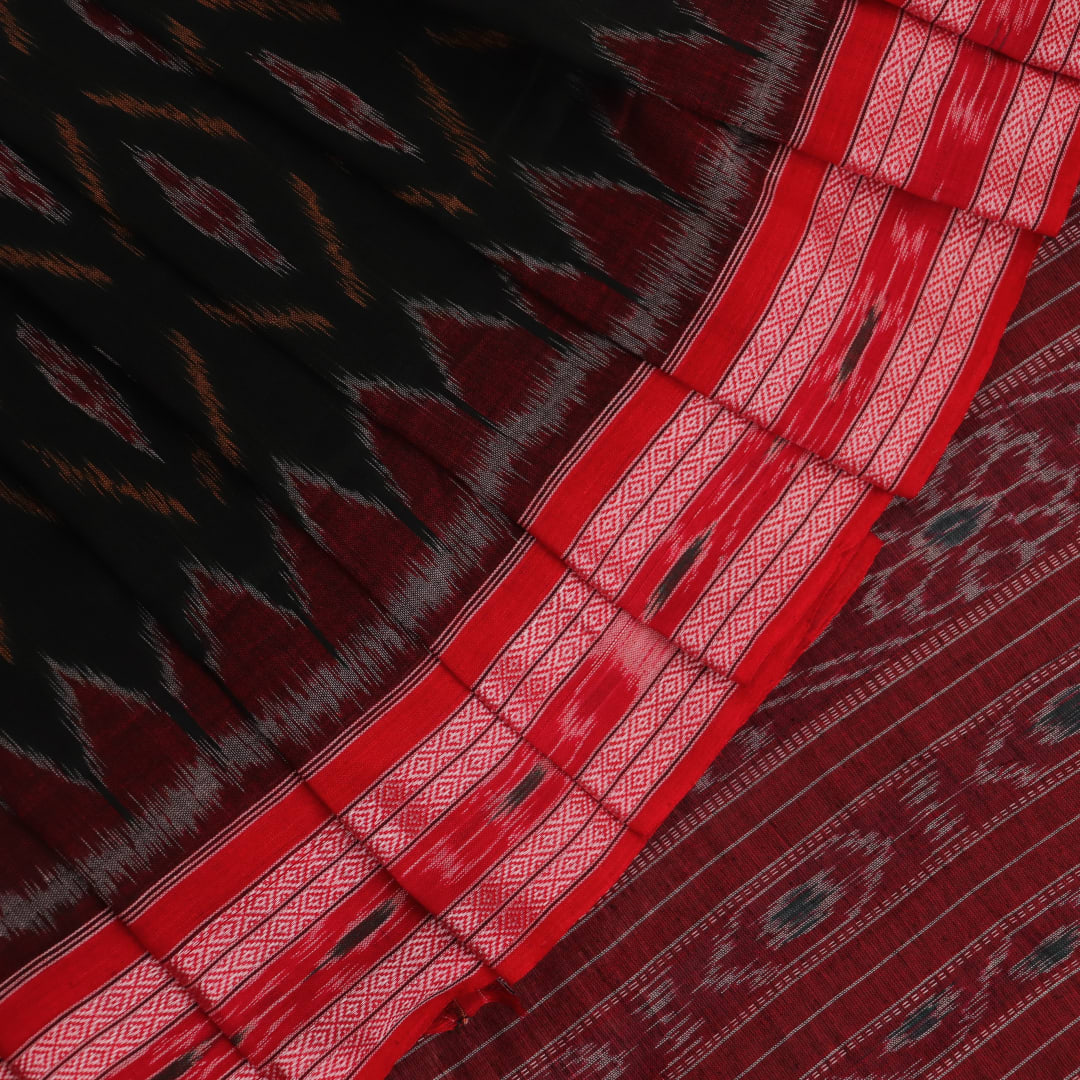 Black and red Sambalpuri cotton saree draped, showcasing its traditional motifs and elegant handloom texture.