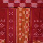 Full drape styling of a brown and maroon Sambalpuri cotton saree with motifs, modeled for elegant look.