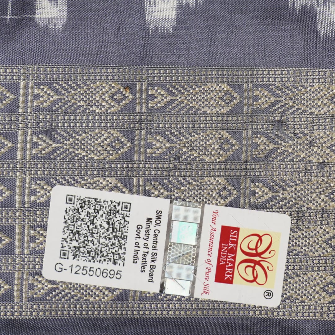 Close-up of the soft, luxurious grey Sambalpuri silk fabric texture with subtle weave details.