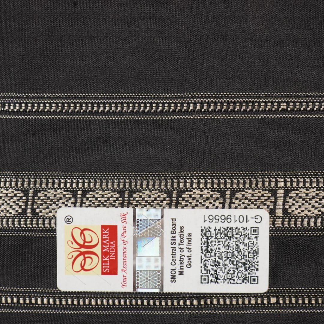 Extreme close-up revealing the fine handloom texture and intricate weave of the Bomkai silk fabric.