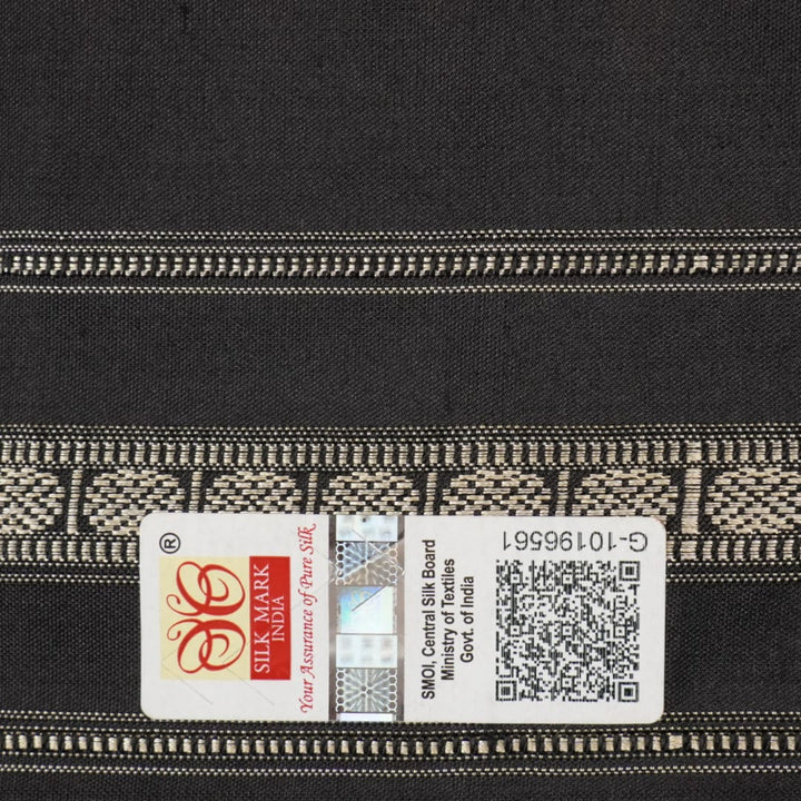 Extreme close-up revealing the fine handloom texture and intricate weave of the Bomkai silk fabric.