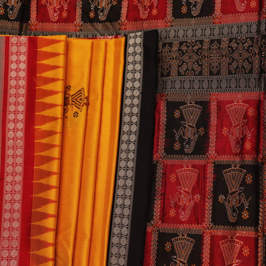 Close-up showcasing the smooth, golden-yellow silk texture of the Bomkai saree, adorned with intricate black butta patterns.
