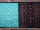 Close-up of light and dark blue silk fabric with intricate butta pattern woven in