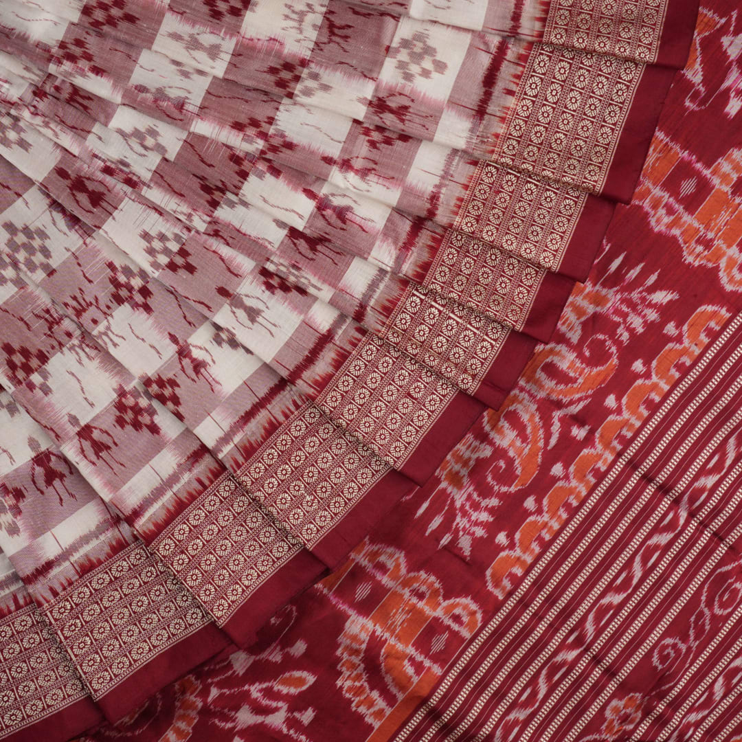 Close-up of the Sambalpuri silk saree fabric, detailing its luxurious texture and fine handloom weave.