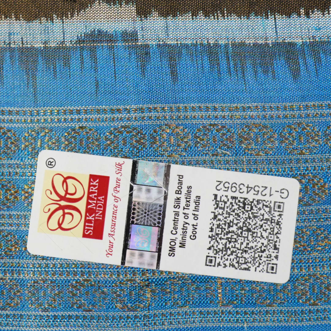 Close-up of Sambalpuri silk saree fabric, revealing rich blue multi-color weave texture and tissue motifs.