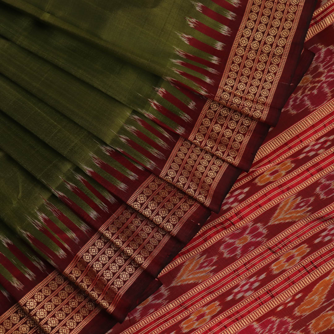 Styling view of vibrant green Khandua silk saree with maroon butta pattern