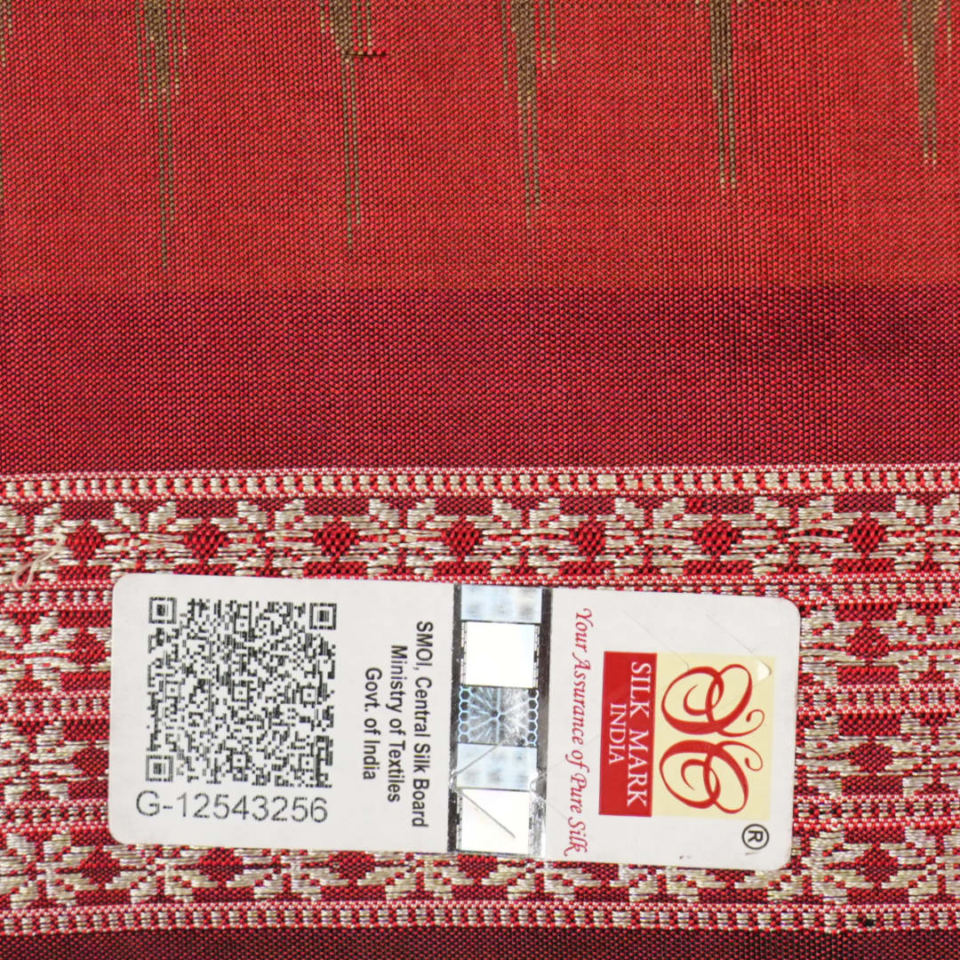 Close-up of Bomkai Silk Saree fabric, highlighting its luxurious brown silk texture and intricate weave.