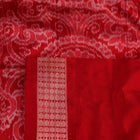 Close-up of grey Sambalpuri silk saree fabric showing intricate motif texture.