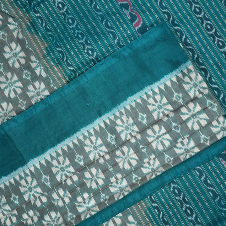 Close-up revealing the luxurious silk texture and subtle motif weave of the blue Sambalpuri saree.
