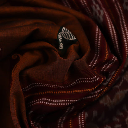A brown and red Bomkai cotton saree with butta pattern on display