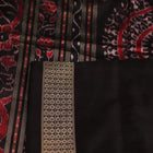 Close-up of handloom Sambalpuri silk saree fabric texture; white with subtle black motifs.