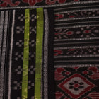 Styled green and black cotton Sambalpuri handloom saree with motifs, showcasing its elegant drape.
