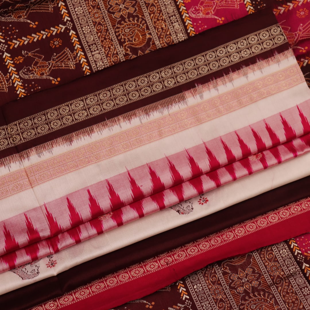 Close-up view of the woven fabric texture, showcasing the intricate butta patterns on the white silk body.