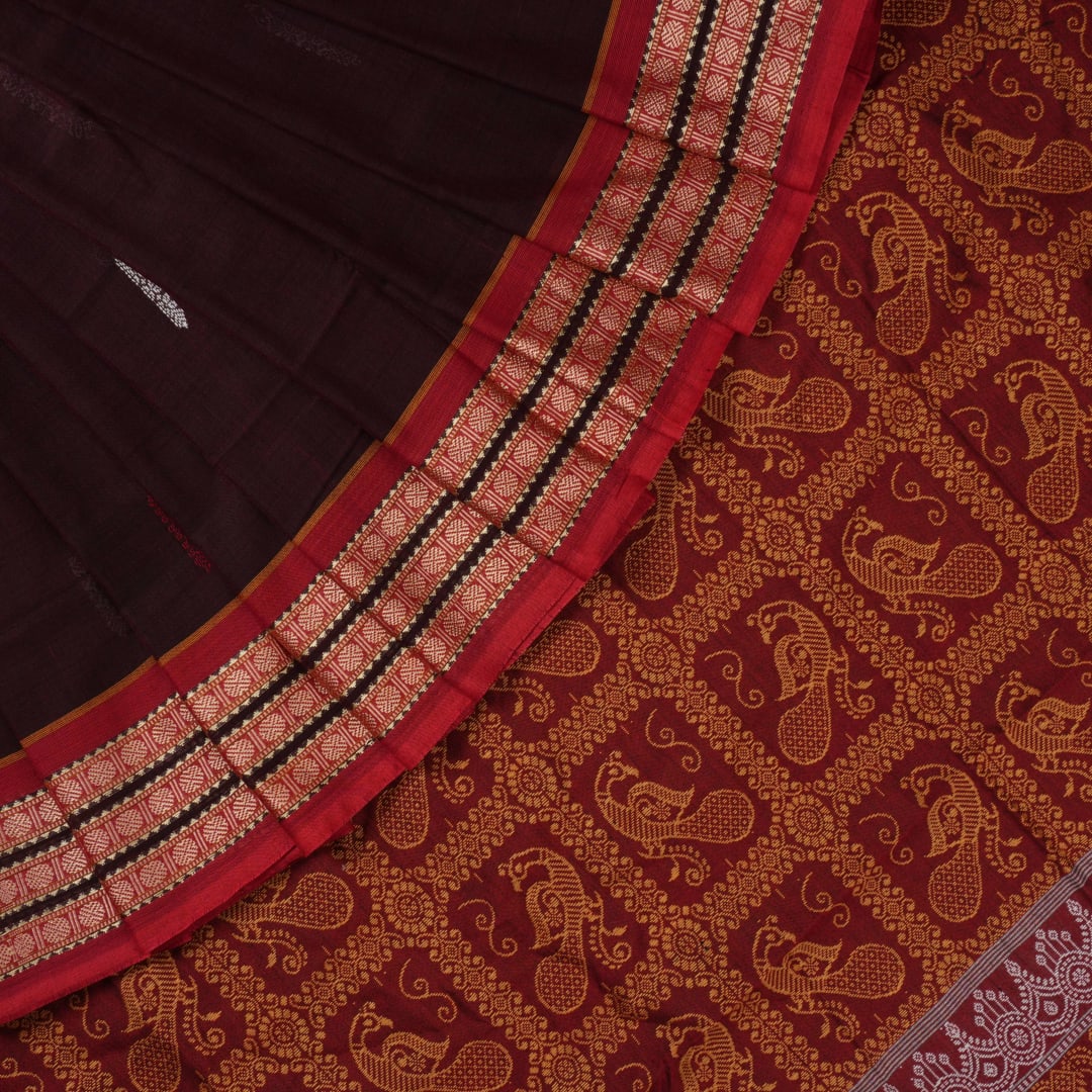 Full view of the maroon Bomkai cotton saree with red borders and small butta motifs laid out flat.