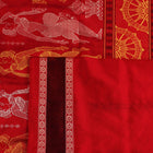 Close-up of Bomkai silk saree fabric texture in black and red, detailing the woven butta pattern.