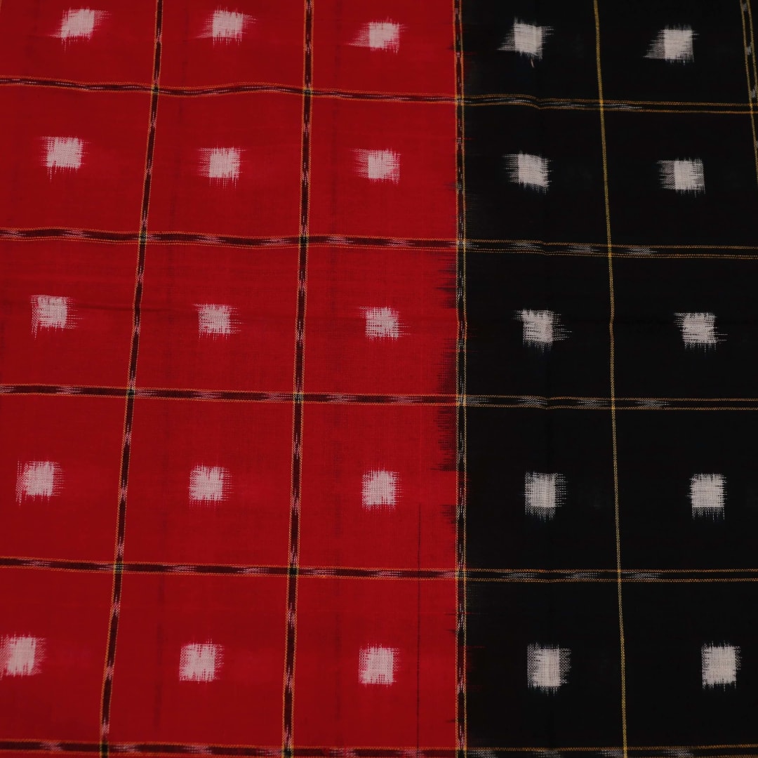 Red and black Sambalpuri cotton dupatta with intricate motifs, styled elegantly