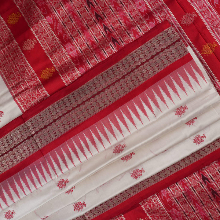 Extreme close-up revealing the rich Bomkai silk fabric texture and intricate handloom weave details in white and red.