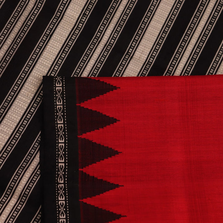 Close-up of the red and black plain silk fabric texture of a Berhampuri saree