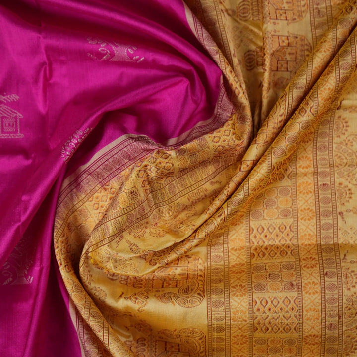 Close-up of the luxurious Bomkai silk saree fabric texture and weave in pink and yellow.