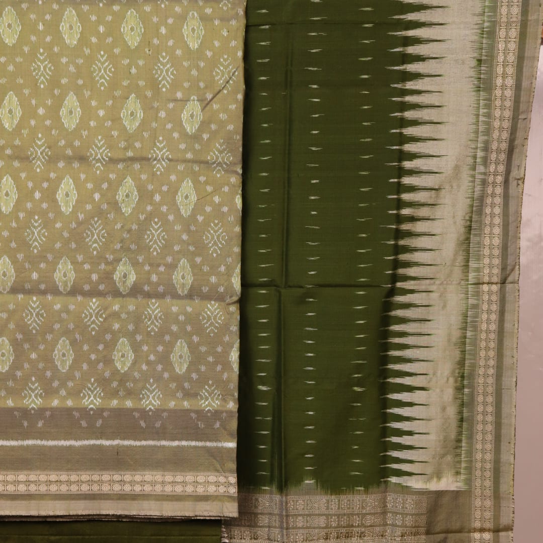Detail of green Bomkai silk dress material's blouse piece with intricate motifs.