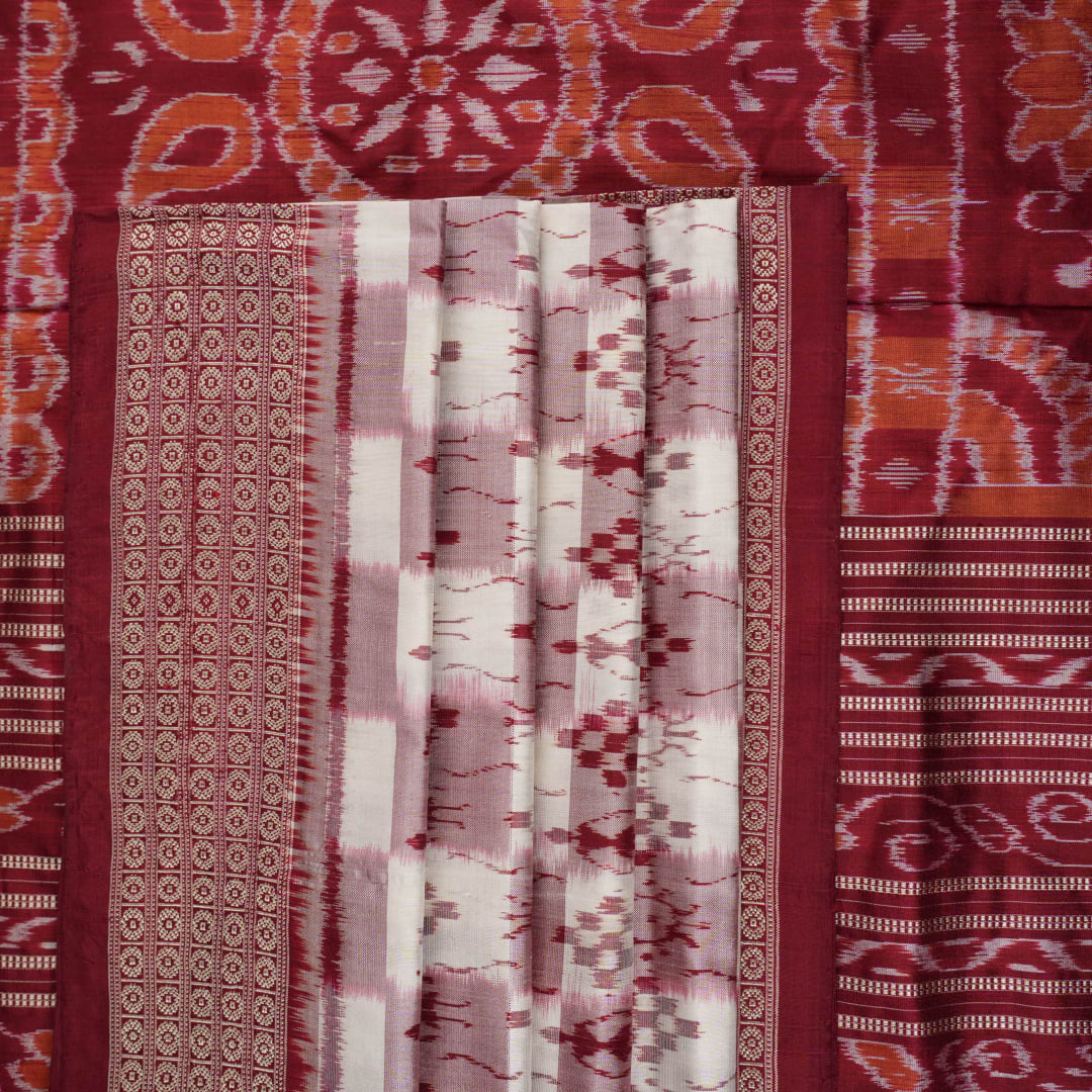 Close-up of the Sambalpuri silk saree fabric, detailing its luxurious texture and fine handloom weave.