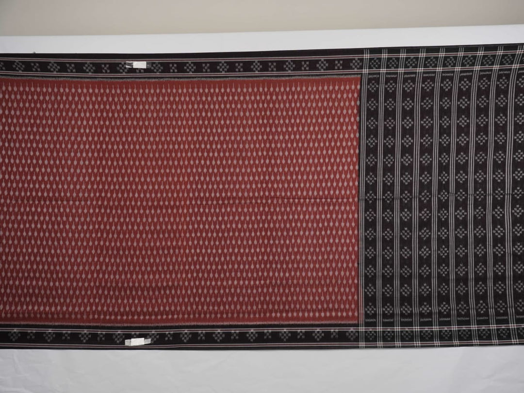 Full styling view of a model draped in a brown and black Sambalpuri cotton saree with traditional motifs.