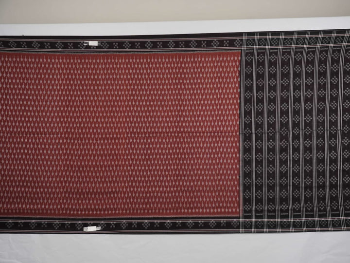 Full styling view of a model draped in a brown and black Sambalpuri cotton saree with traditional motifs.