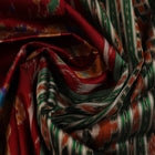 Maroon and green Khandua silk saree with intricate motifs draped elegantly