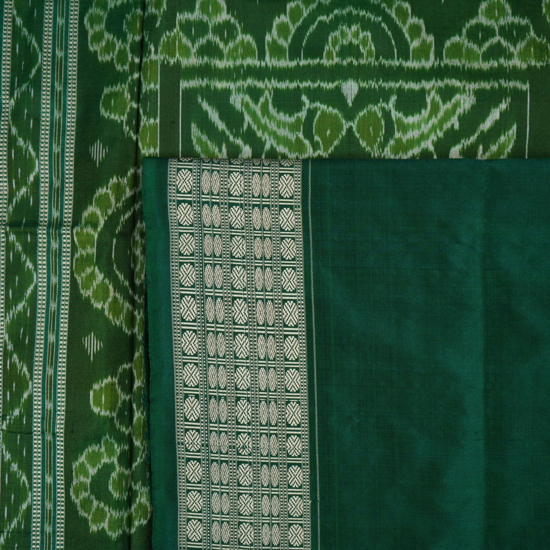 Ultra close-up of green Sambalpuri silk saree fabric, highlighting its luxurious texture and weave.