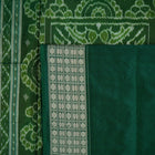 Ultra close-up of green Sambalpuri silk saree fabric, highlighting its luxurious texture and weave.