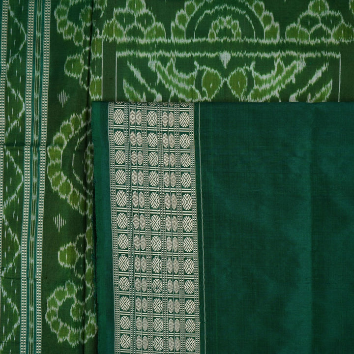 Ultra close-up of green Sambalpuri silk saree fabric, highlighting its luxurious texture and weave.