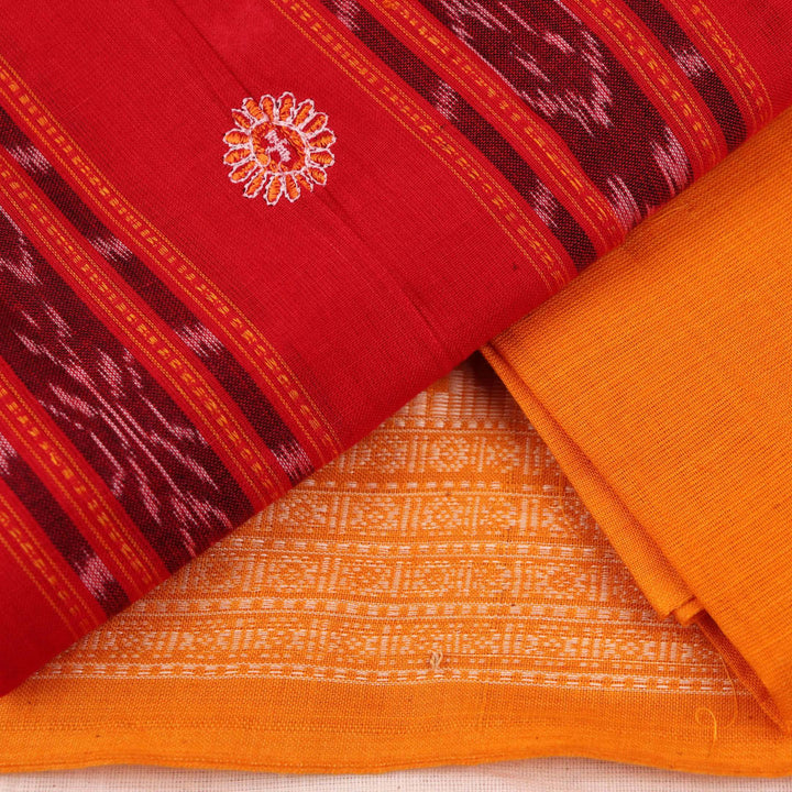 Close-up view of a red and yellow cotton Sambalpuri dress material with intricate motif patterns