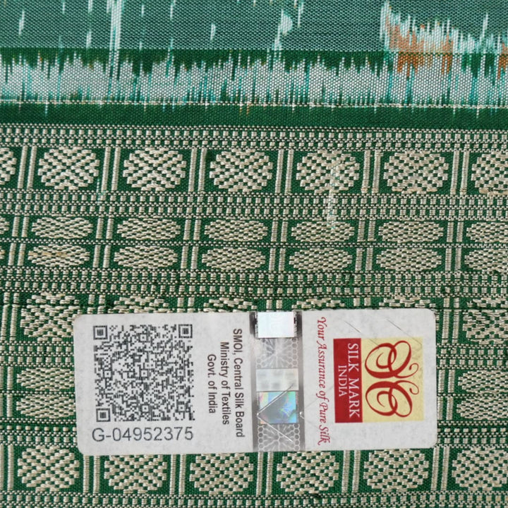 Ultra close-up of green Sambalpuri silk saree fabric, highlighting its luxurious texture and weave.