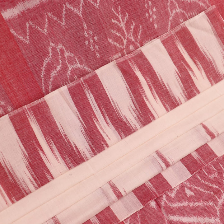 Plain white and maroon Sambalpuri cotton saree styled to show its drape and color combination.