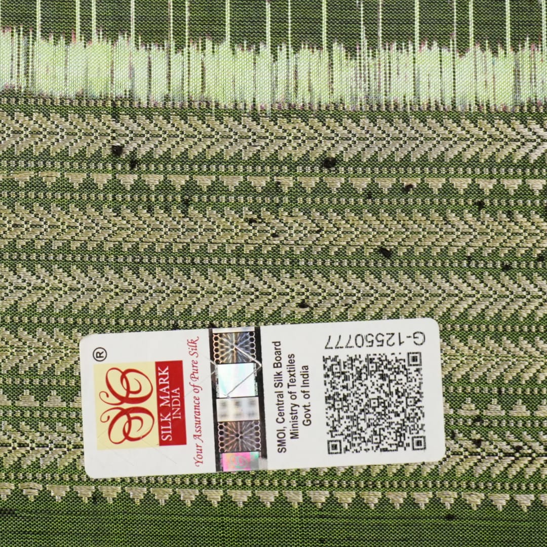 Ultra close-up of green Sambalpuri silk fabric, revealing its unique texture and fine weave.
