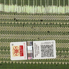 Ultra close-up of green Sambalpuri silk fabric, revealing its unique texture and fine weave.