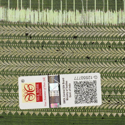 Ultra close-up of green Sambalpuri silk fabric, revealing its unique texture and fine weave.
